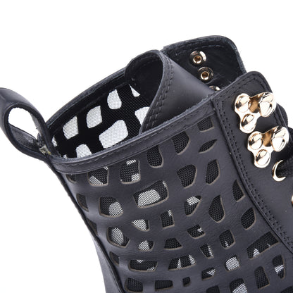 Combat boots in black laser-cut calfskin